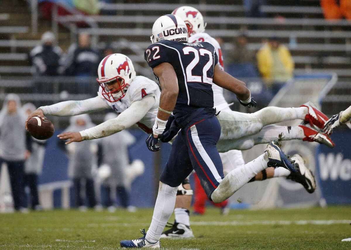 Southern Methodist quarterback Matt Davis (4) dives for a touchdown in front of Connecticut safety Andrew Adams (22) during the third quarter of an NCAA college football game in East Hartford, Conn., Saturday, Dec. 6, 2014. SMU won 27-20. (AP Photo/Michael Dwyer)
