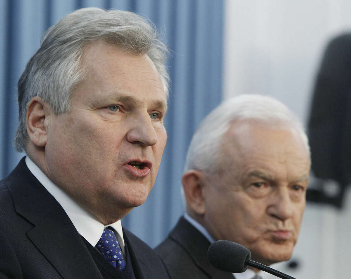 Former President Aleskander Kwasniewski,left, and former Prime Minister Leszek Miller, who were in power when the CIA ran a secret prison in Poland, speak to reporters a day after the publication of a report that sheds lights on the CIA program that involved the torture of detainees, in Warsaw, Poland, Wednesday, Dec.10, 2014. (AP Photo/Czarek Sokolowski)