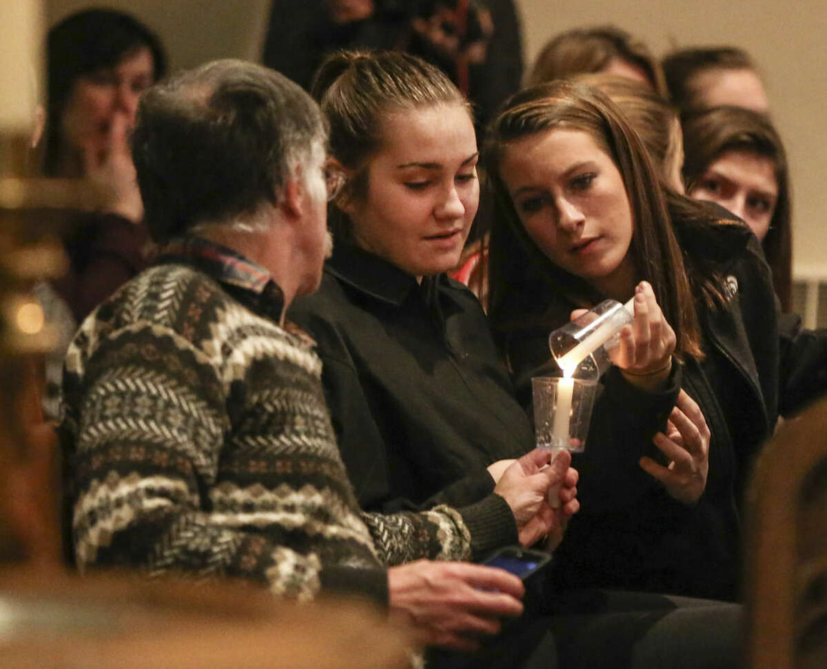 People attend a community prayer vigil at the Emmanuel Evangelical Lutheran Church in Souderton, Pa. for the shooting victims of Bradley W. Stone, in Montgomery County, Pa., Tuesday, Dec. 16, 2014. An Iraq War veteran suspected of killing his ex-wife and five of her relatives was found dead of self-inflicted stab wounds Tuesday in the woods of suburban Philadelphia, ending a day-and-a-half manhunt that closed schools and left people on edge. (AP Photo/The Philadelphia Daily News, Steven M. Falk) THE EVENING BULLETIN, TV OUT, MAGS OUT, NO SALES