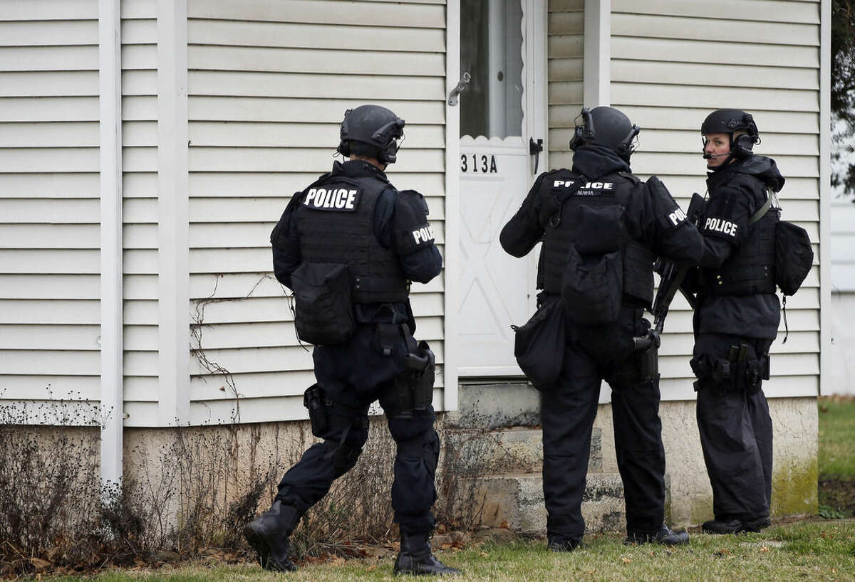 Police search for suspect Bradley William Stone, Tuesday, Dec. 16, 2014, in Pennsburg, Pa. Schools closed and hospitals and other public places tightened security Tuesday, as police in suburban Philadelphia hunted for the Marine veteran suspected of killing his ex-wife and five of her relatives. (AP Photo/Matt Rourke)