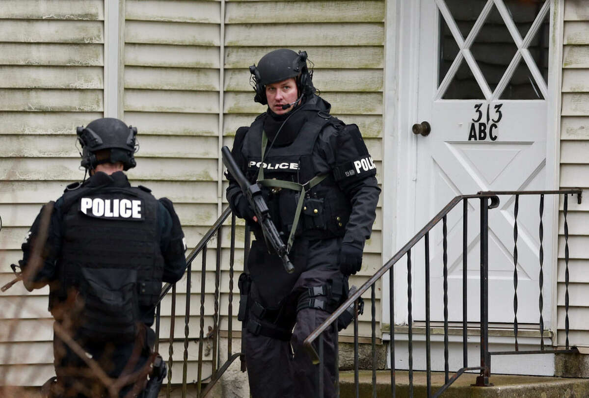 Police search for suspect Bradley William Stone, Tuesday, Dec. 16, 2014, in Pennsburg, Pa. Schools closed and hospitals and other public places tightened security Tuesday, as police in suburban Philadelphia hunted for the Marine veteran suspected of killing his ex-wife and five of her relatives. (AP Photo/Matt Rourke)