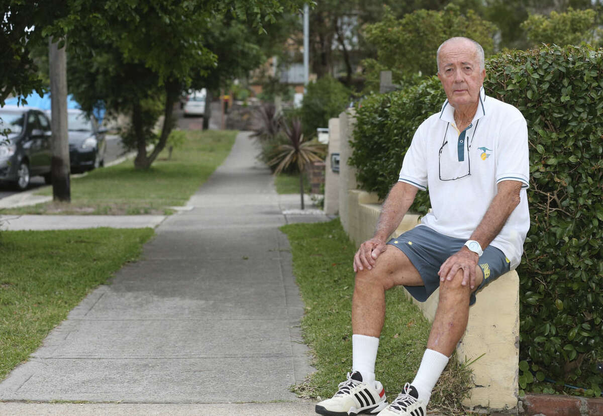 John O'Brien, one of hostages of the Sydney cafe siege, poses for a photo as he relaxes in his front yard in Sydney, Australia, Wednesday, Dec. 17, 2014. O'Brien, 82, was the first hostage to escape the Lindt Chocolat Cafe after a gunman took 17 people hostage on Monday Dec. 15. Three people including the gunman were shot after police ended the siege at the coffee shop early Tuesday. (AP Photo/Rob Griffith)