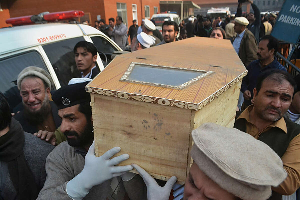 People carry the casket of a victim of Taliban attack in a school, after receiving it from a local hospital in Peshawar, Pakistan, Tuesday, Dec. 16, 2014. Taliban gunmen stormed a military school in the northwestern Pakistani city of Peshawar on Tuesday, killing and wounding dozens, officials said, in the latest militant violence to hit the already troubled region. (AP Photo/Mohammad Sajjad)