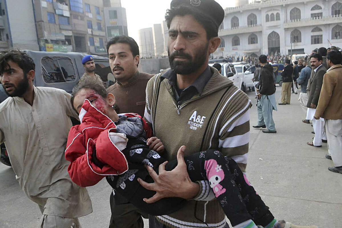 A Pakistani girl, who was injured in a Taliban attack in a school, is rushed to a hospital in Peshawar, Pakistan, Tuesday, Dec. 16, 2014. Taliban gunmen stormed a military-run school in the northwestern Pakistani city of Peshawar on Tuesday, killing and wounding scores, officials said, in the highest-profile militant attack to hit the troubled region in months.(AP Photo/Mohammad Sajjad)
