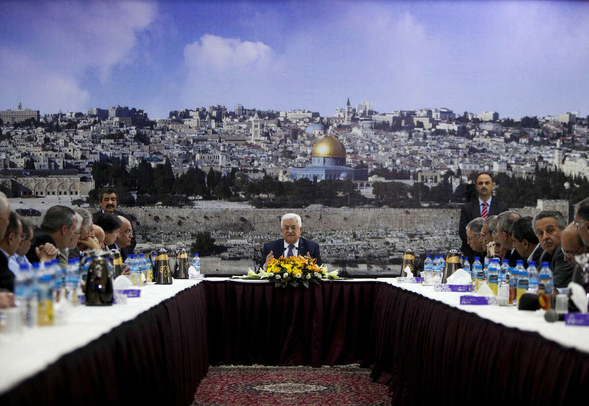 FILE - In this April 1, 2014 file photo Palestinian President Mahmoud Abbas talks during a leadership meeting in Ramallah. The examples from recent weeks signal that disagreeing with Abbas and his inner circle comes at a price for Palestinians. Critics say that after a decade in power, Abbas has created an increasingly authoritarian system with little room for dissent. (AP Photo/Majdi Mohammed, File)