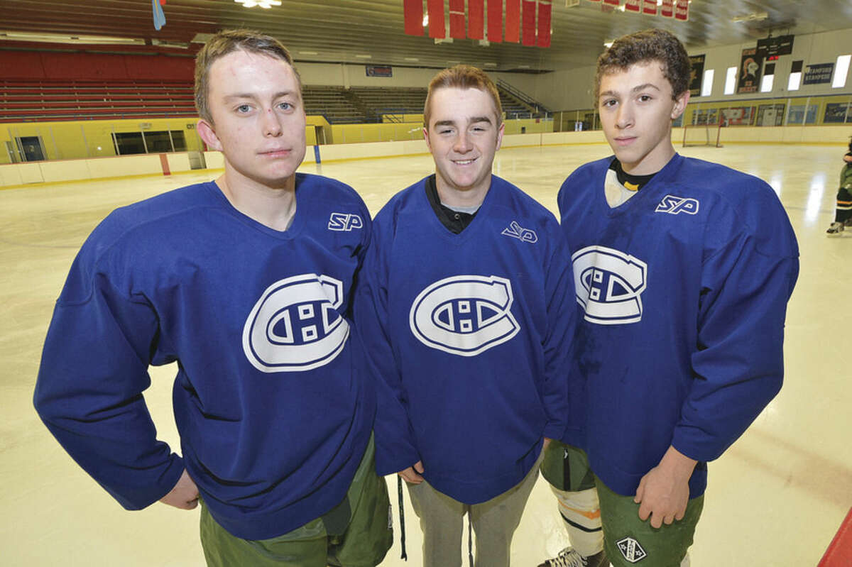 Photo by Alex von Kleydorff Trinity Catholic hockey captains are, from left, Matt Carlson, Griffin Northrop, and Joey Nelson, who are looking to rebuild the Crusaders programs.