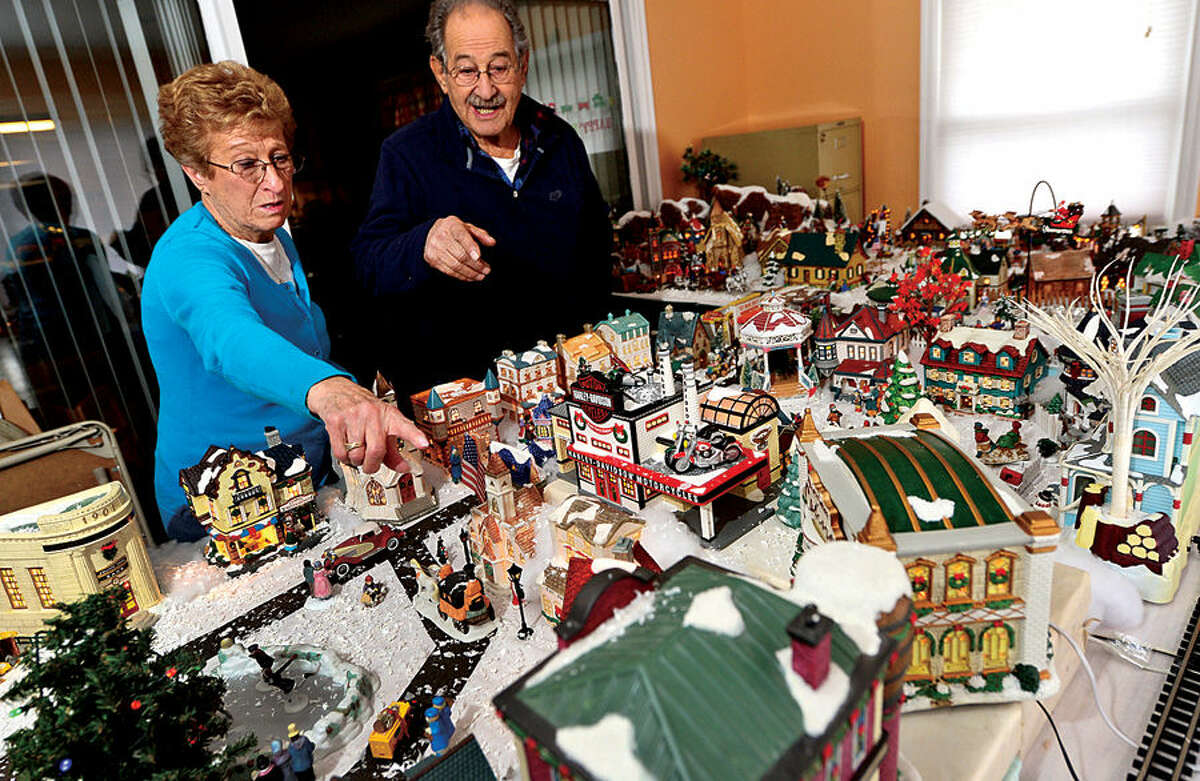 Hour photo / Erik Trautmann Norwalk resident, 80-year-old Pat Scarpone, his wife Diane, and their extended family have constructed an elaborate model Christmas Village in their home every year for the past 25 years .