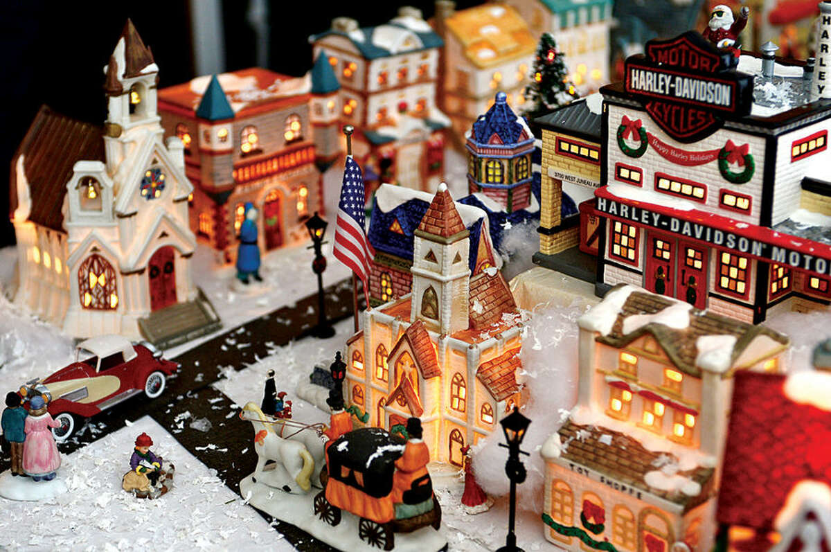 Hour photo / Erik Trautmann Norwalk resident, 80-year-old Pat Scarpone, his wife Diane, and their extended family have constructed an elaborate model Christmas Village in their home every year for the past 25 years .