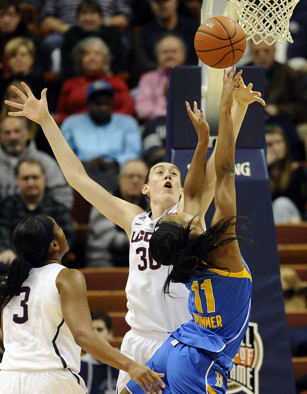 Connecticut’s Breanna Stewart, left, blocks a shot attempt by UCLA’s Lajahna Drummer, right, during the first half of an NCAA college basketball game, Sunday, Dec. 21, 2014, in Uncasville, Conn. (AP Photo/Jessica Hill)