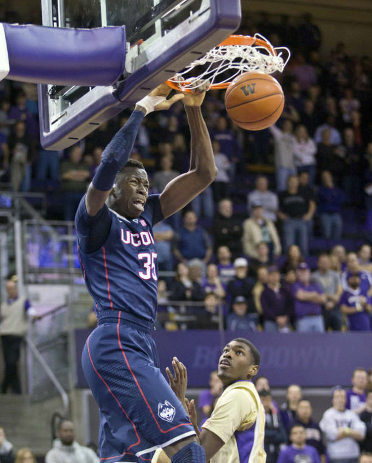 Connecticut's Amida Brimah dunks against Washington in the first half of an NCAA college basketball game in Seattle on Sunday, Dec. 22, 2013. (AP Photo/John Froschauer)