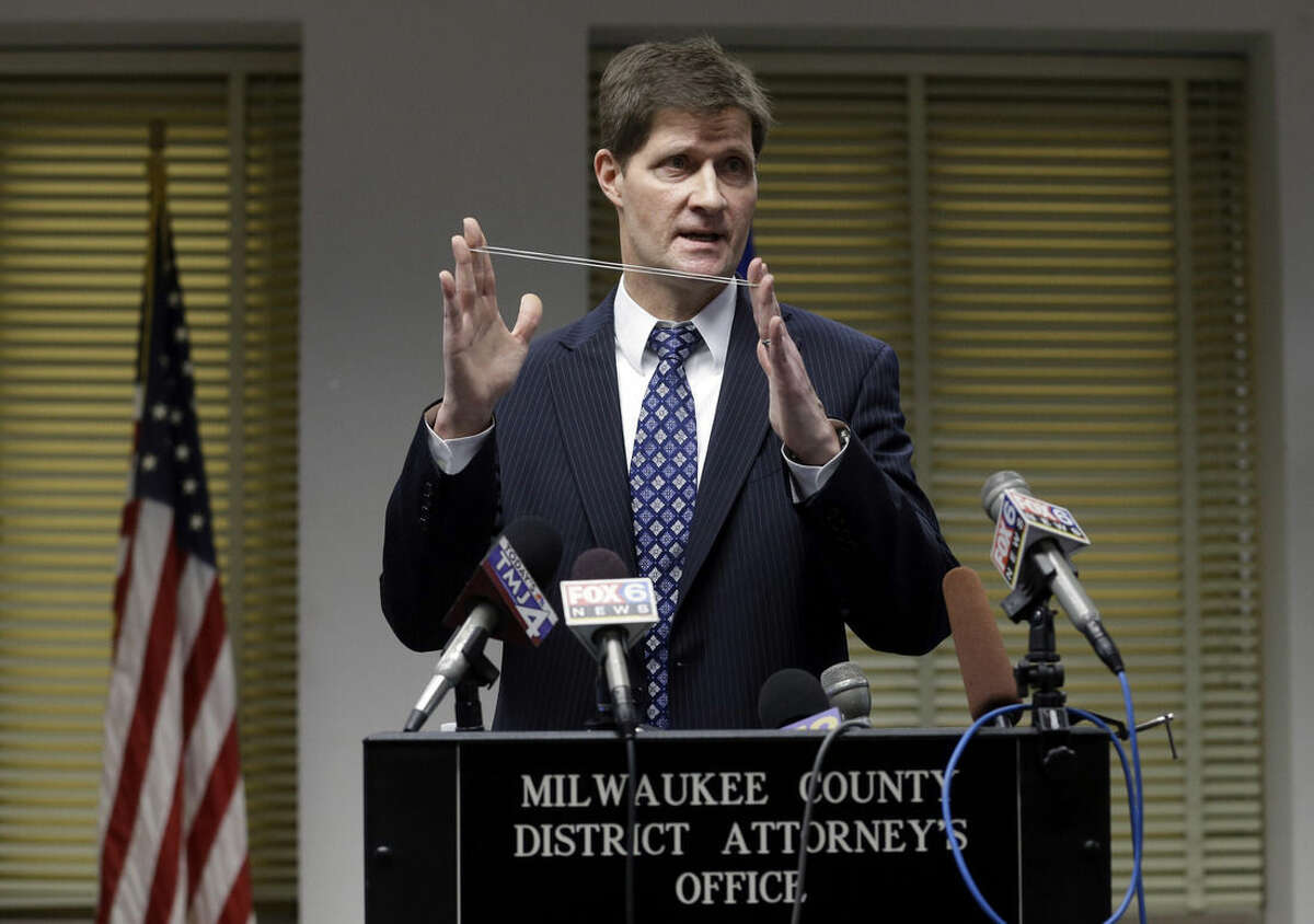 Milwaukee County District Attorney John Chisholm demonstrates bullet trajectory at news conference Monday, Dec. 22, 2014, in Milwaukee. Chisholm announced that there would be no charges against former police office Christopher Manney in the fatal shooting of Dontre Hamilton. (AP Photo/Morry Gash)
