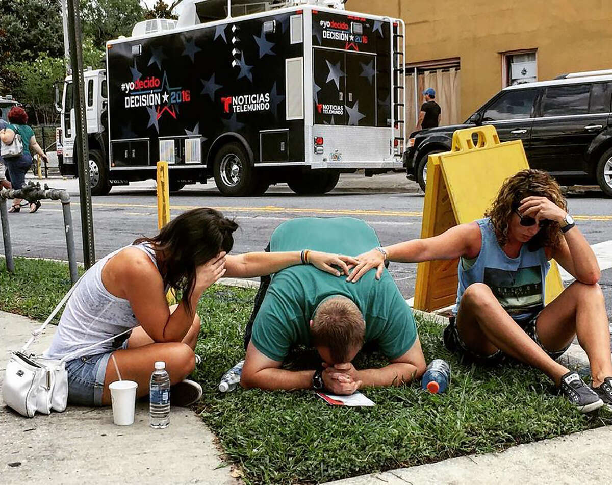 TOPSHOT - In this photo courtesy of the Instagram site of the_pixel_trappa, shows people mourning for victims of the mass shooting near the Pulse gay nightclub in Orlando, Florida, on June 12, 2016. Fifty people died and another 53 were injured when a gunman opened fire and seized hostages at a gay nightclub in Florida, police said June 12, making it the worst mass shooting in US history. / AFP PHOTO / the_pixel_trappa / Handout / RESTRICTED TO EDITORIAL USE - MANDATORY CREDIT "AFP PHOTO / INSTAGRAM/the_pixel_trappa" - NO MARKETING - NO ADVERTISING CAMPAIGNS - DISTRIBUTED AS A SERVICE TO CLIENTS HANDOUT/AFP/Getty Images