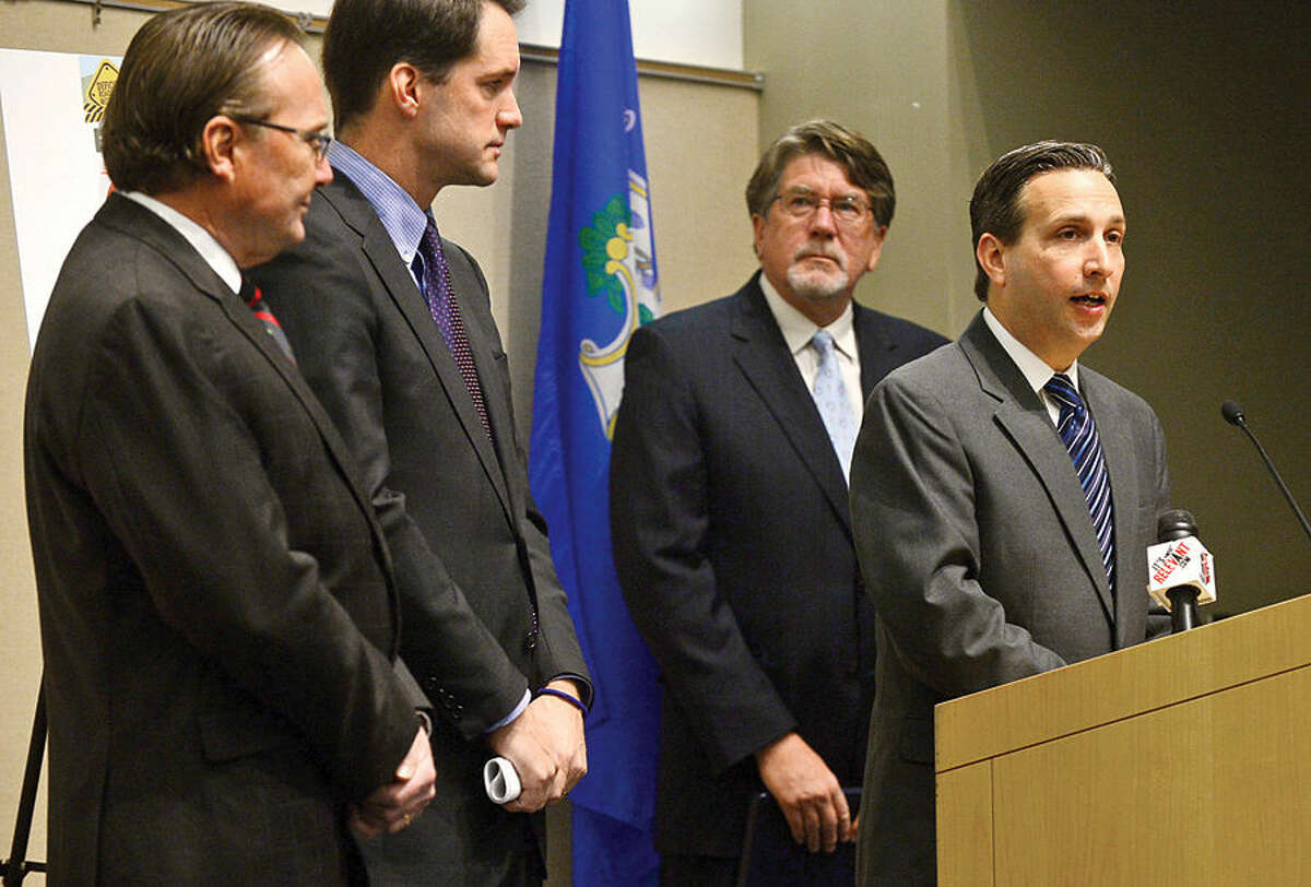 Congressman Jim Himes discusses the recent transportation infrastructure study completed by TRIP, a national transportation research group, during a news conference at the University of Connecticut’s Stamford campus Tuesday, as Jack Condlin, president and CEO of the Stamford Chamber of Commerce, state Senator Bob Duff and Will Wilkens, executive director of TRIP, look on.