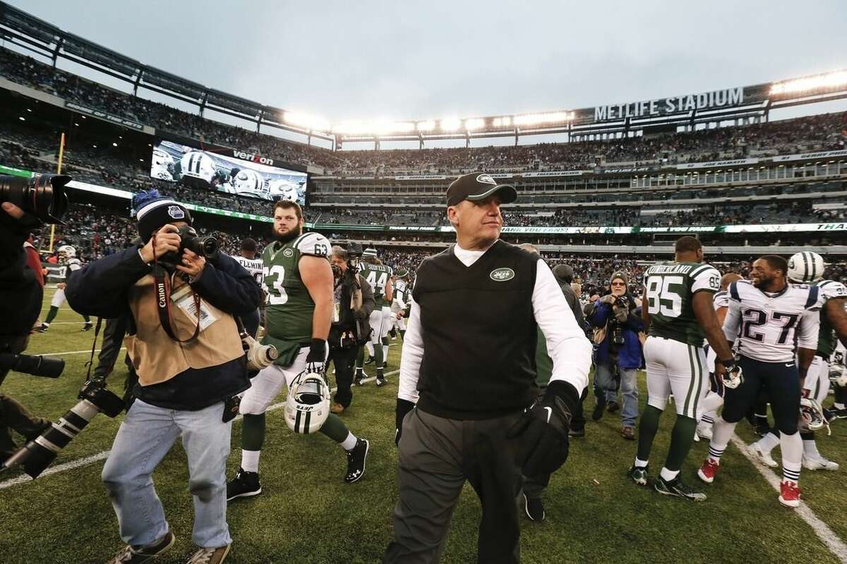 New York Jets head coach Rex Ryan leaves the field after an NFL football game against the New England Patriots Sunday, Dec. 21, 2014, in East Rutherford, N.J. The Patriots won the game 17-16. (AP Photo/Julio Cortez)