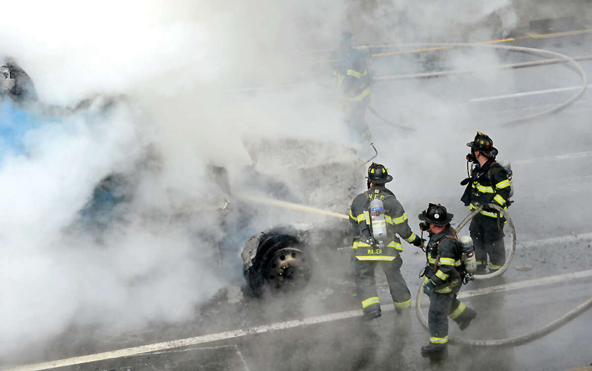 Hour photo / Erik Trautmann Norwalk firefighters fight a tractor trailer fire on I-95 Southbound at exit 14 Thursday morning