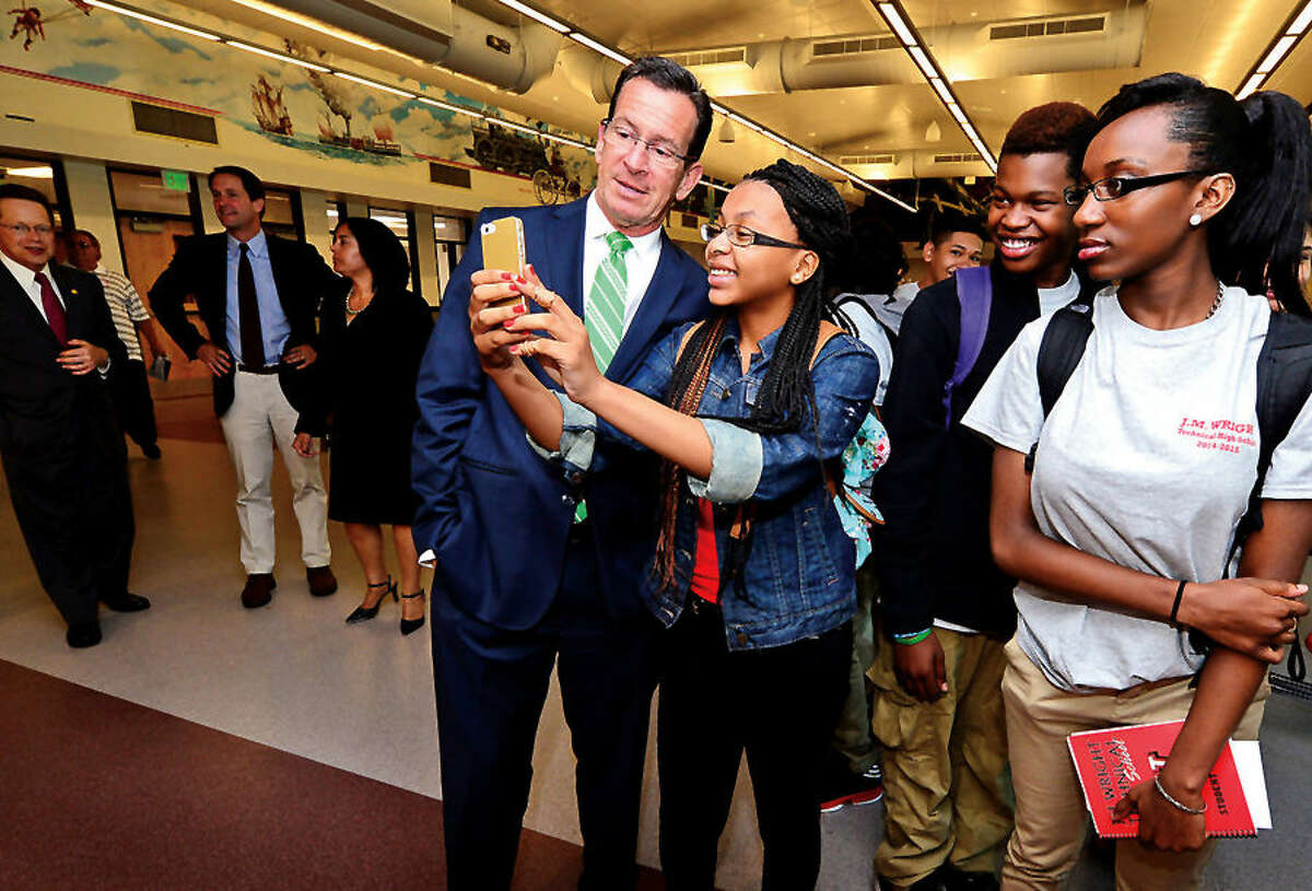 Hour photo / Erik Trautmann Connecicut Governor Dannell Malloy takes a selfie with student Chanya Champagne following the J.M. Wright Technical School Opening Day ribbon cutting ceremony Wednsaday morning.