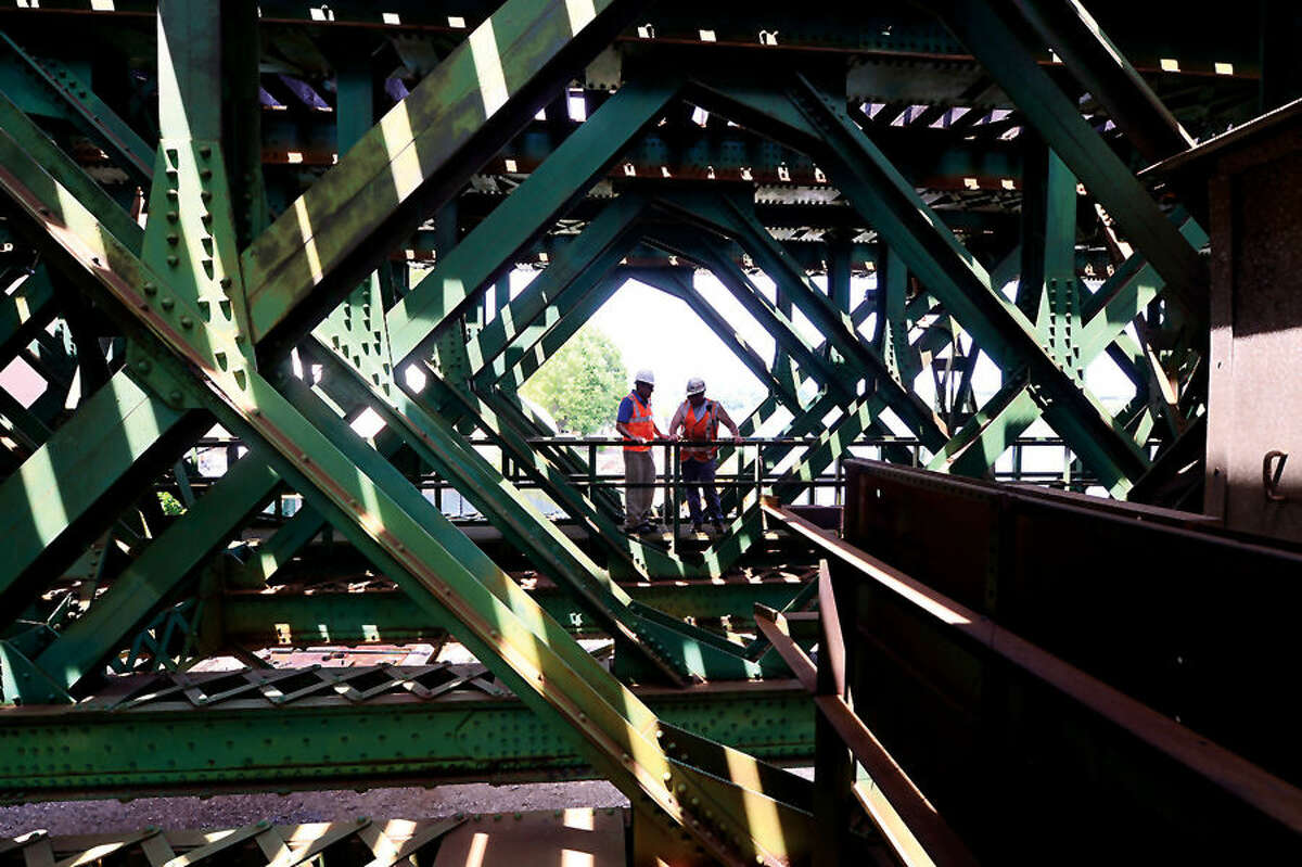 Hour photo / Erik Trautmann Metro-North Railroad and CT DOT officials give local media a tour of the inner workings of the 118-year-old Walk train bridge in Norwalk Wednesday.