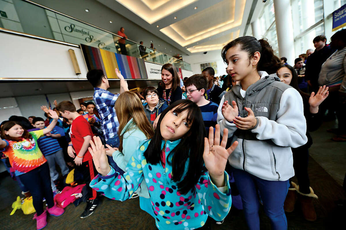 Hour photo / Erik Trautmann Roxbury Elementary School Stamford Education 4 Autism (SE4A) buddy Genna Diaz dances to the opening music as Stamford Education 4 Autism hosts a World Autism Awareness Day celebration at the Stamford Government Center Wednesday morning.