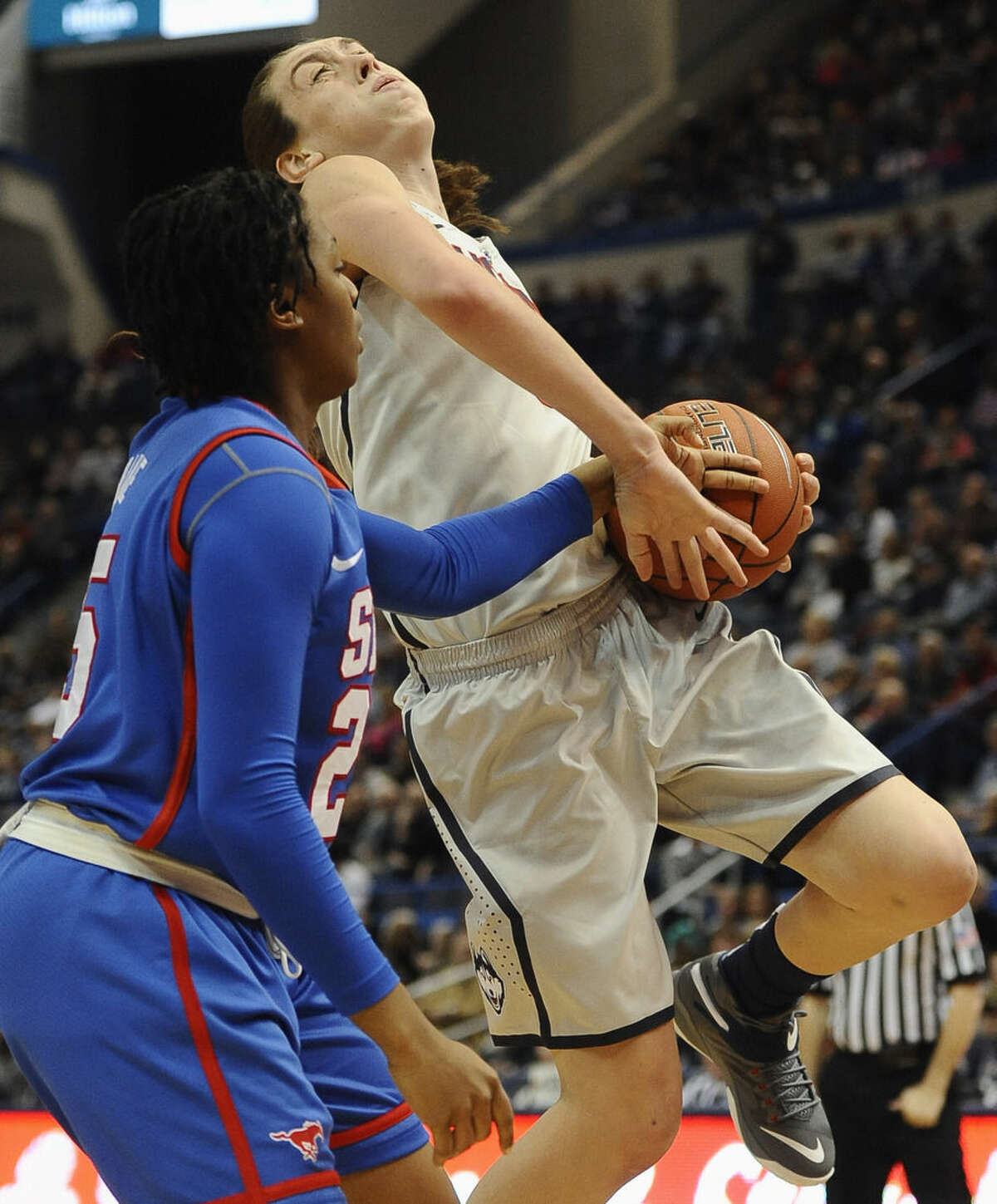 SMU’s Taylor Brame, left, fouls Connecticut’s Breanna Stewart, right, during the first half of an NCAA college basketball game, Saturday, Dec. 27, 2014, in Hartford, Conn. (AP Photo/Jessica Hill)