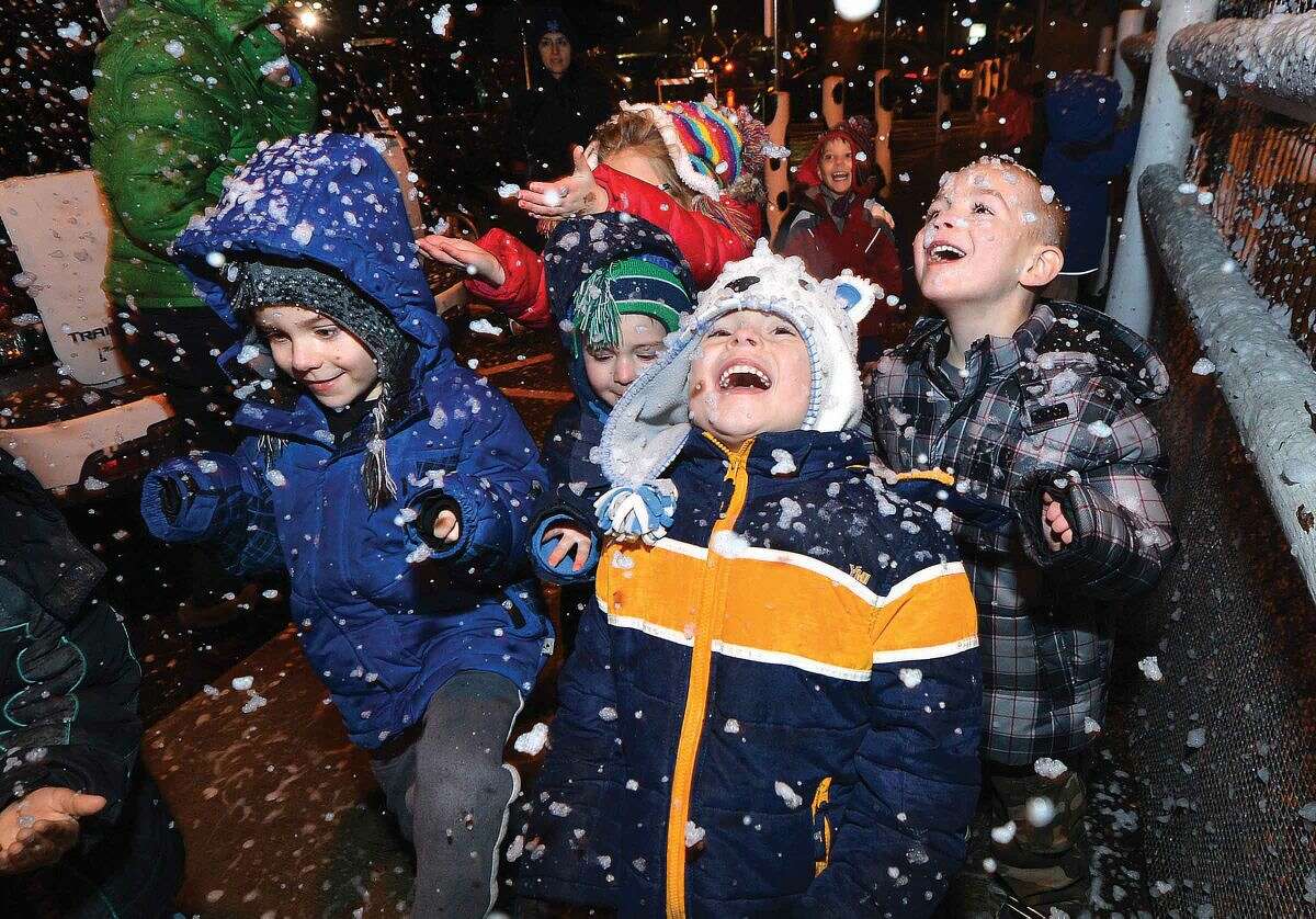 Hour Photo/Alex von Kleydorff 5 yr old Bryson Antoci trys to grab snowflakes falling from snow makers during the Christmas Tree Llighting at Stew Leonard's on Tuesday night