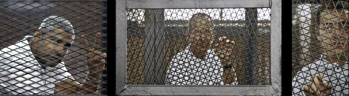 FILE - This combination of three 2014 file photos shows from left, Canadian-Egyptian journalist Mohamed Fahmy, Al-Jazeera's Australian correspondent Peter Greste, and Egyptian producer Baher Mohamed at a court room during their trial in Cairo, Egypt. A year after three Al-Jazeera English journalists were arrested in Egypt, they and their families are pleading for justice and an end to their ordeal. Egypt's Court of Cassation begins hearing their appeal on Thursday, Jan. 1, 2015.(AP Photo/Ahmed Abd El Latif, Hamada Elrasam, File) EGYPT OUT