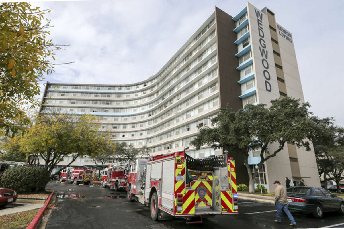 Firefighters and emergency units respond to a fire at the Wedgwood Senior Apartments, Sunday, Dec. 28, 2014 in San Antonio, Texas. Five people died after a fire broke out at the senior-living apartment building in the San Antonio suburb of Castle Hills, authorities said. (AP Photo/San Antonio Express-News, Marvin Pfeiffer)