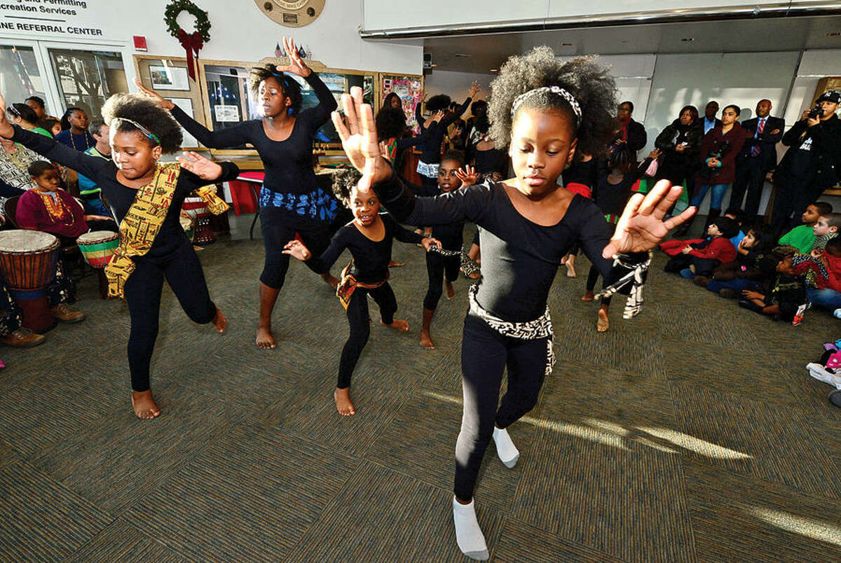 Hour photo / Erik Trautmann The Dance Like David Dancers perform in Stamford’s 20th annual Kwanzaa celebration Tuesday at the Stamford Government Center.