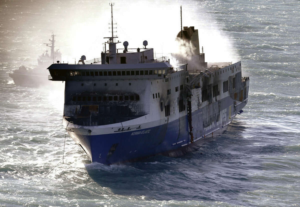 Smoke billows from the Italian-flagged Norman Atlantic ferry that caught fire in the Adriatic Sea, Tuesday, Dec. 30, 2014. A blaze broke out on the car deck of the Norman Atlantic Sunday, Dec. 28, while the ferry was traveling from the Greek port of Patras to Ancona in Italy causing the death of at least 11 people. Italian and Greek helicopter rescue crews evacuated 427 people among passengers and crew members but Italian officials think the death toll could be much higher because of serious discrepancies in the ship's manifest and confusion over how many people were aboard. "We cannot say how many people may be missing," Italian Transport Minister Maurizio Lupi said at a news conference. The cause of the fire is under investigation. (AP Photo/Antonio Calanni)