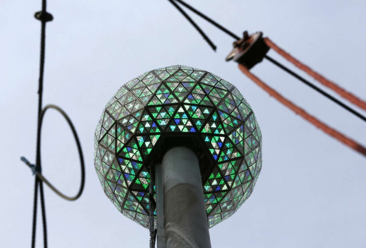 Workers light the Waterford crystal ball during a test for the New Year's Eve celebration atop One Times Square in New York, Tuesday, Dec. 30, 2014. The ball, which is 12 feet in diameter and weighs 11,875 pounds, is decorated with 2,688 Waterford crystals and illuminated by 32,256 LED lights. (AP Photo/Kathy Willens)