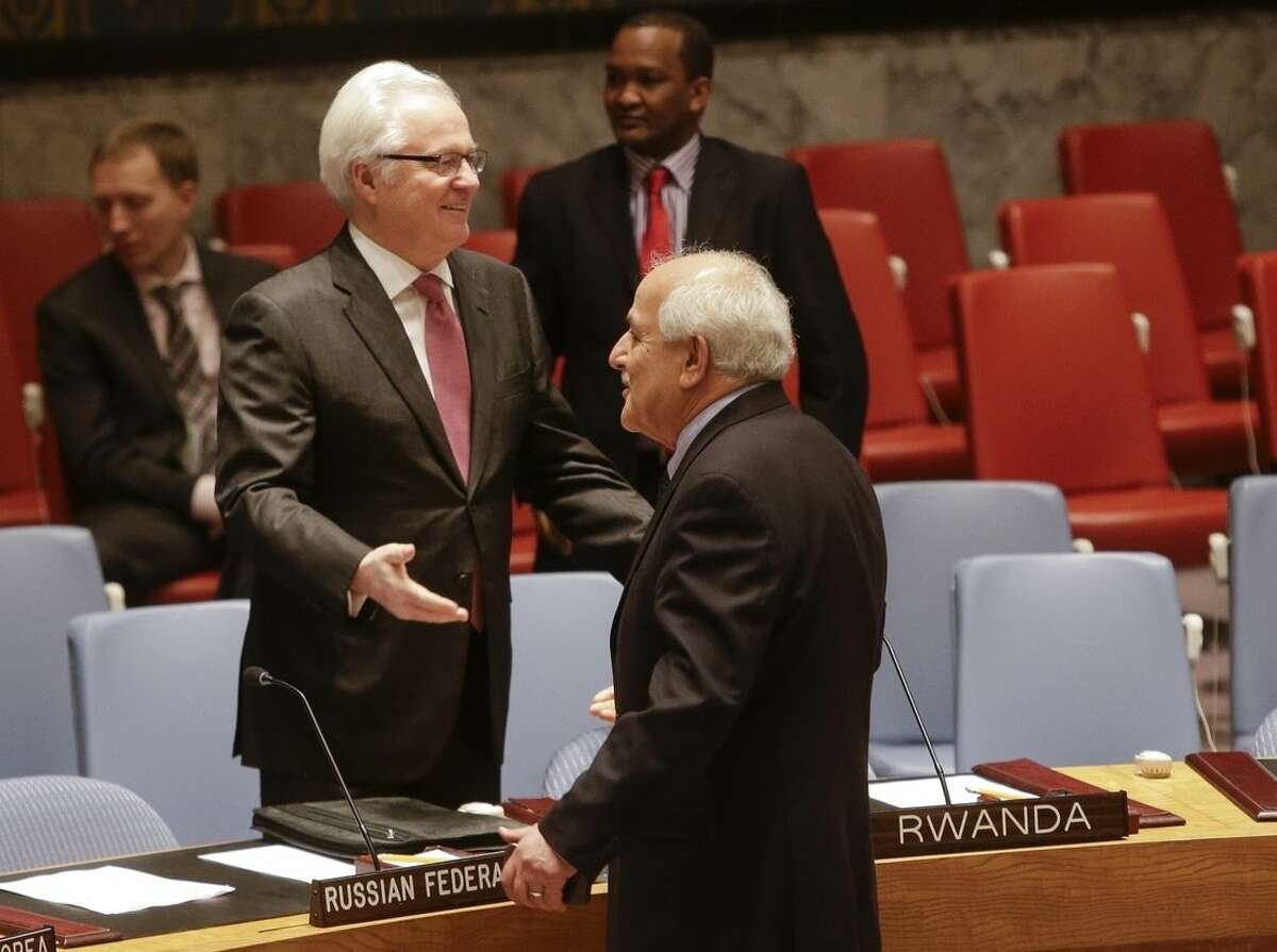 Palestinian Ambassador to the United Nations Riyad Mansour speaks to Russian Foreign Minister Russian Ambassador Vitaly Churkin before a meeting of the U.N. Security Council, Tuesday, Dec. 30, 2014, at the United Nations headquarters. The U.N. Security Council scheduled a vote Tuesday evening on a Palestinian resolution calling for an end to Israel's occupation within three years, a proposal virtually certain to be defeated because of U.S. and Israeli opposition. (AP Photo/Frank Franklin II)