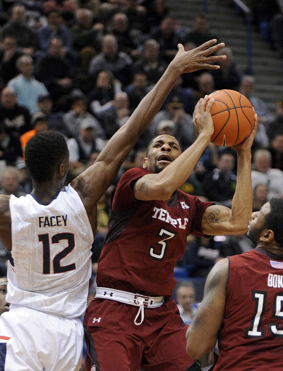Temple's Jesse Morgan (3) drives past Connecticut's Kentan Facey (12) during the first half of an NCAA college basketball game in Hartford, Conn., on Wednesday, Dec. 31, 2014. (AP Photo/Fred Beckham)