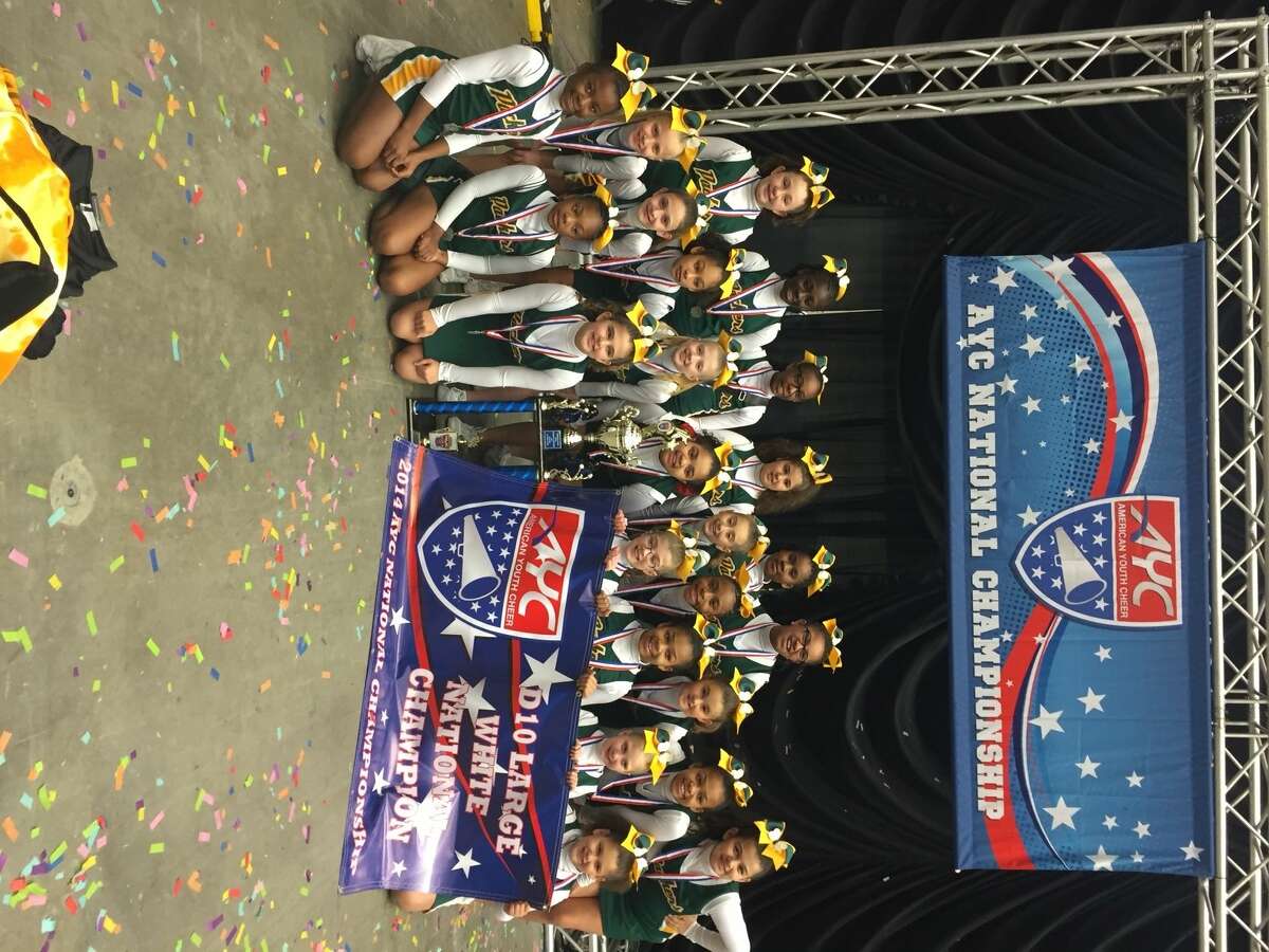 The U-10 Norwalk Packers cheerleaders with their National Championship banner and trophy after winning second consecutive National Championship Sunday night.