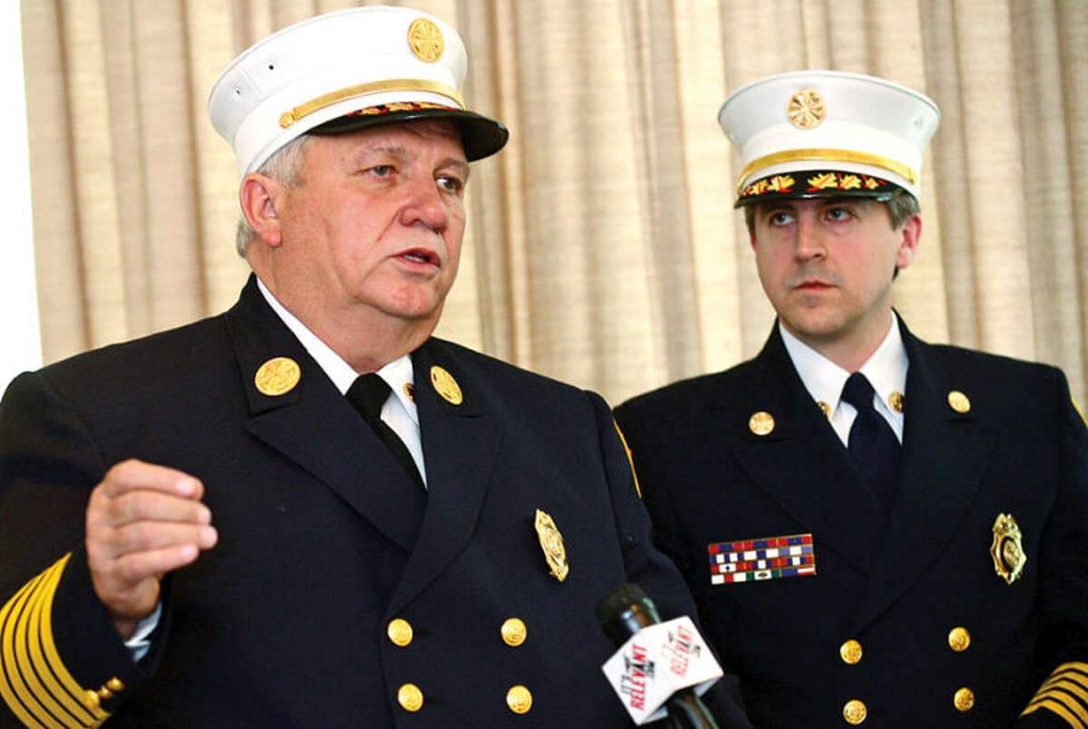 Hour photo / Erik Trautmann Stamford Fire Chief Peter Brown and Turn Of River (TOR) Chief Frank Jacobellis comment on the signing of an agreement to consolidate the City and Turn of River Volunteer Fire Departments during a press conference Wednesday.
