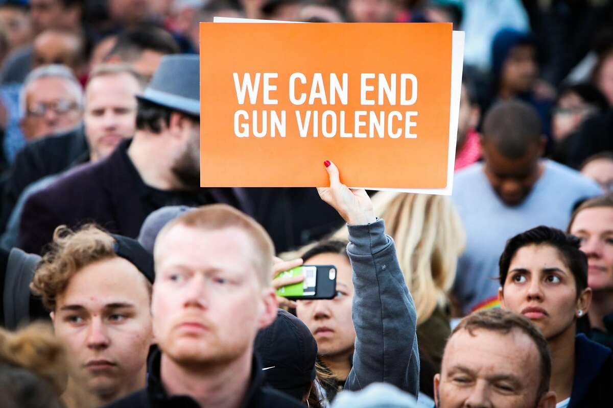 A woman holds up a sign against gun violence, during a vigil to commemorate victims of the Orlando massacre, in San Francisco, California, on Sunday, June 12, 2016.