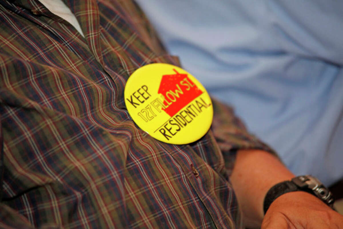 Pins were worn by those against the Al-Madany Islamic Center of Norwalk's plan for 27,000-square-foot mosque/community center at 127 Fillow St during a meeting in which the application was denied inside City Hall Wednesday afternoon. Hour Photo / Danielle Robinson