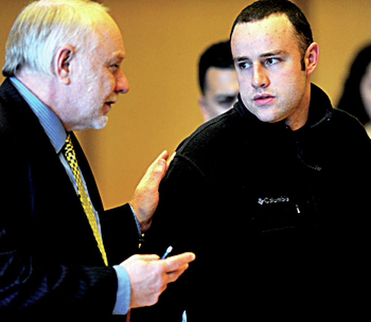 Aaron Ramsey of Wilton, right, sits beside his lawyer, Howard Ehring, left, as Ramsey is found not guilty by reason of mental disease or deficiency by a three-judge panel during a verdict reading at state Superior Court in Stamford on Wednesday, December 12, 2012. Ramsey was on trial for beating his father, Edward, to death in May after Ramsey allegedly heard voices.