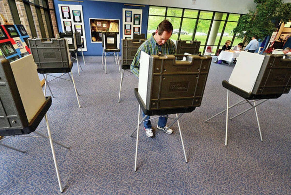 File photo of Wilton residents voting at Wilton High School. Hour photo / Erik Trautmann