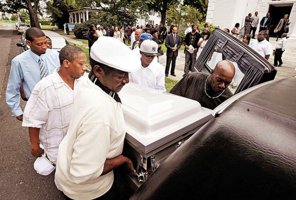 Pallbearers take the body of Amos Brown Jr. for burial following the funeral service at the First Congregational Church on the Green Tuesday morning.