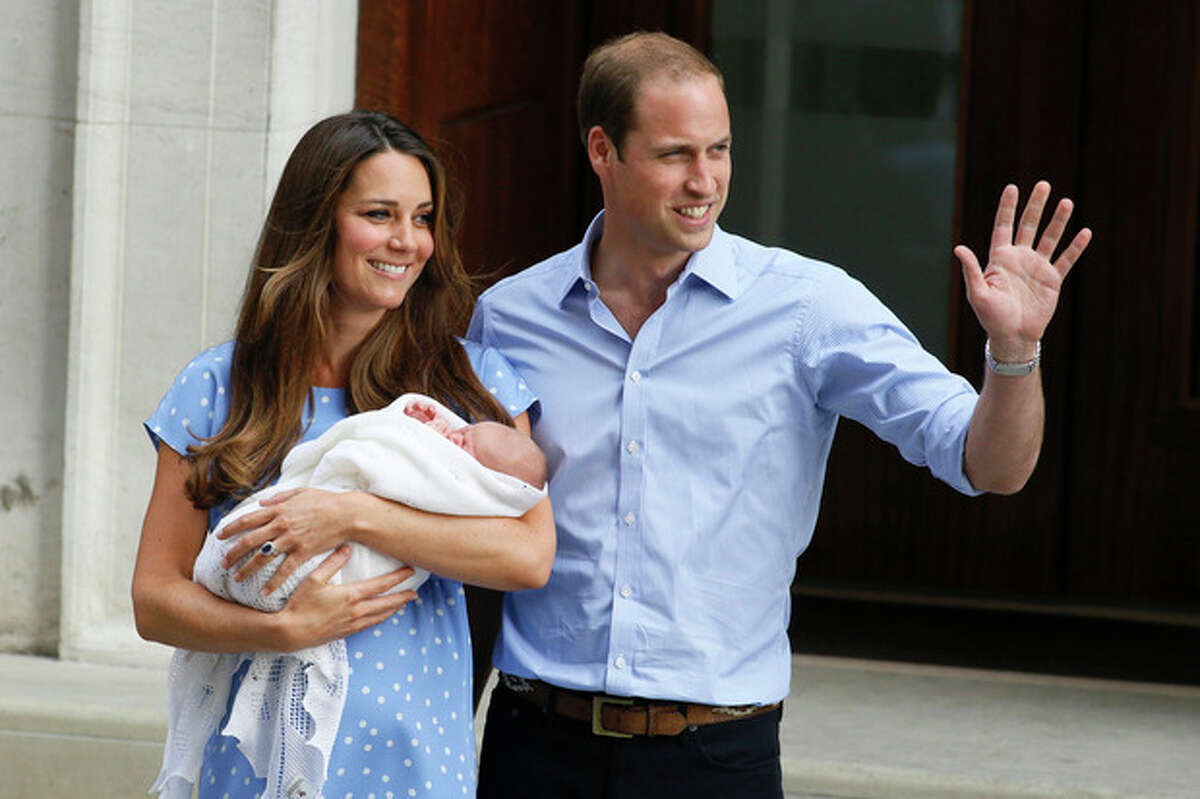 Britain's Prince William, right, and Kate, Duchess of Cambridge, hold the Prince of Cambridge, Tuesday July 23, 2013, as they pose for photographers outside St. Mary's Hospital exclusive Lindo Wing in London where the Duchess gave birth on Monday July 22. The Royal couple are expected to head to London?’s Kensington Palace from the hospital with their newly born son, the third in line to the British throne. (AP Photo/Kirsty Wigglesworth)
