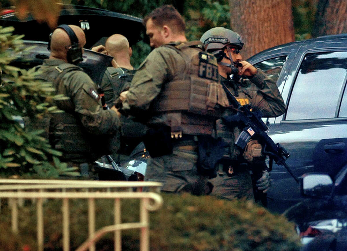 Members of the FBI suit up outside the residence of Miriam Carey in Stamford, Conn. Thursday, Oct. 3, 2013. Law-enforcement authorities have identified Carey, 34, as the woman who, with a 1-year-old child in her car, led Secret Service and police on a harrowing chase in Washington from the White House past the Capitol Thursday, attempting to penetrate the security barriers at both national landmarks before she was shot to death, police said. The child survived. (AP Photo/The Stamford Advocate, Christian Abraham) MANDATORY CREDIT