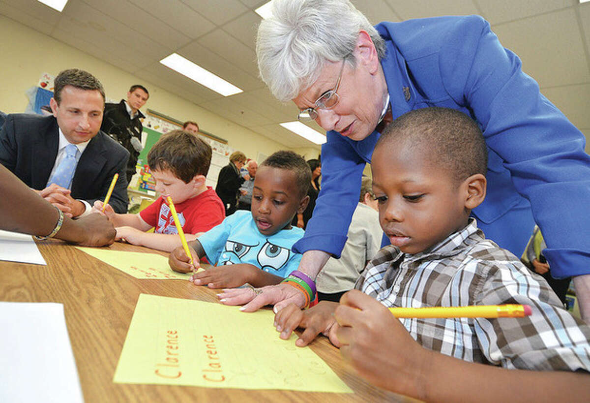 Hour Photo/Alex von Kleydorff . Lt. Governor Nancy Wyman visits the Norwalk Brighter Futures program at Marvin Elementary school and helps Clarence Joseph with a handwriting exercise.
