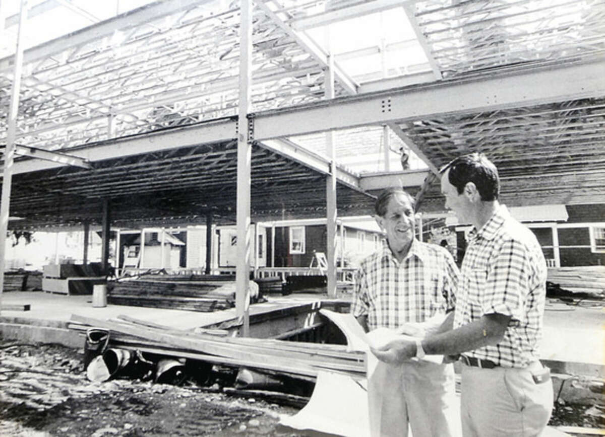 Hour photo / Erik Trautmann Hour photo / Erik Trautmann Owner of Joseph A. Marino Contractors, Lew Marino, right, with his father, the late Joseph A. Marino, at the company's first development, Joseph A. Marino Square, on Main Ave. The company is celebrating their 75th anniversary this year.