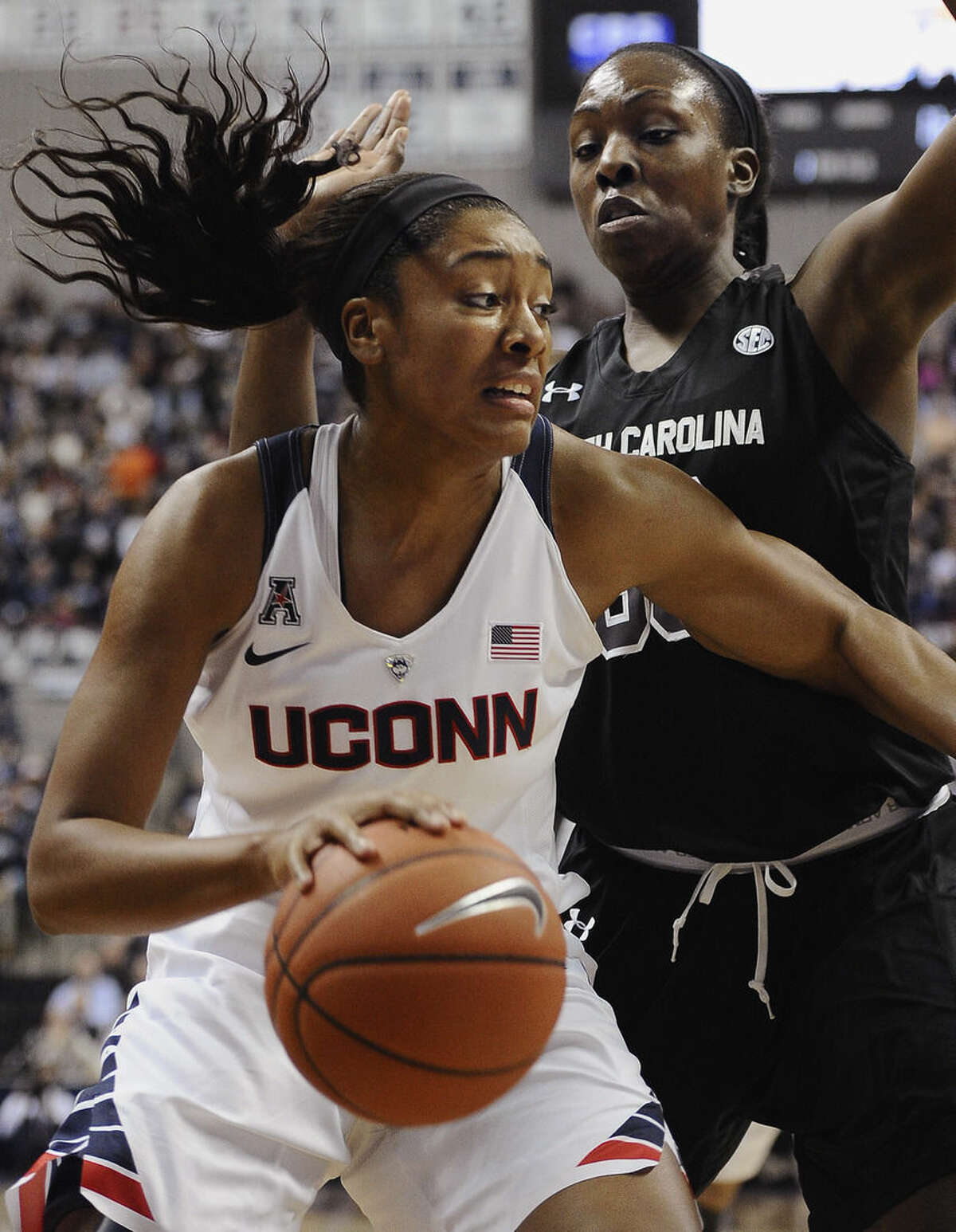 Connecticut’s Morgan Tuck, left, drives to the basket as South Carolina’s Elem Ibiam, right, defends during the first half of an NCAA college basketball game, Monday, Feb. 9, 2015, in Storrs, Conn. (AP Photo/Jessica Hill)