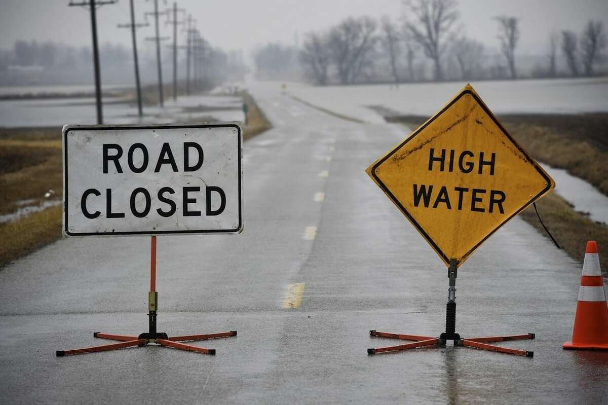 High water closes a stretch of Kentucky 812/Airline Road Wednesday, March 4, 2015. Nearly 2.5 inches of rain has fallen since Tuesday evening, causing some highways in Henderson, Union and Webster counties to be closed because of flooding. (AP Photo/The Gleaner, Mike Lawrence)