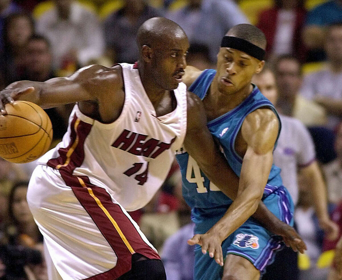 FILE - In this April 23, 2001 file photo, Miami Heat's Anthony Mason, left, drives against the Charlotte Hornets' P.J. Brown, right, in the first quarter of an NBA Basketball game in Miami. The New York Knicks spokesman Jonathan Supranowitz confirmed Saturday, Feb. 28, 2015 that Mason, a rugged power forward who was a defensive force for several NBA teams in the 1990s, has died. He was 48. (AP Photo/Amy E. Conn)