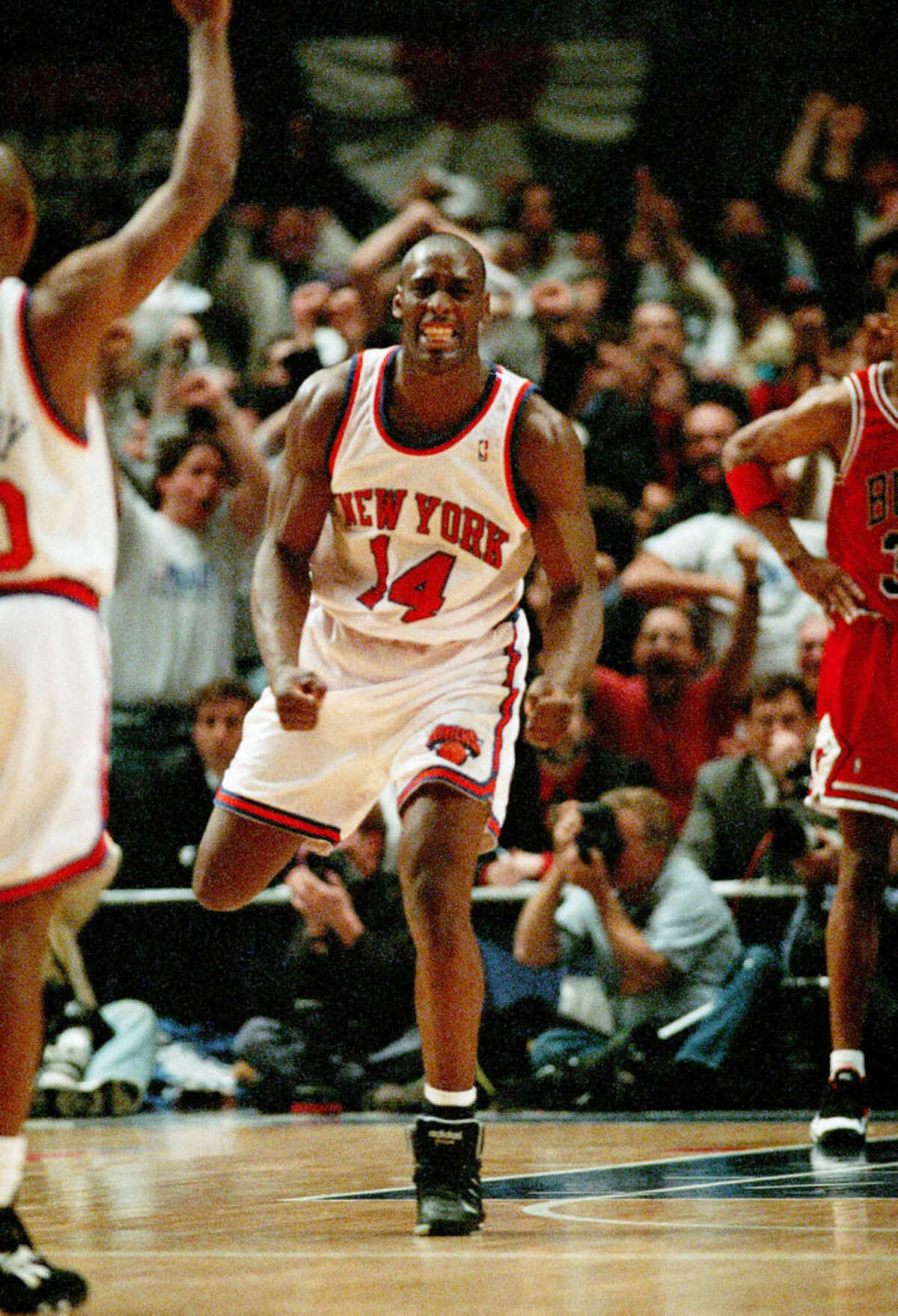 FILE - In this May 8, 1994 file photo, New York Knicks Anthony Mason (14) celebrates as the Knicks pull within one point of the Chicago Bulls during the fourth period of the NBA Eastern Conference Semifinal game in New York. The New York Knicks spokesman Jonathan Supranowitz confirmed Saturday, Feb. 28, 2015 that Mason, a rugged power forward who was a defensive force for several NBA teams in the 1990s, has died. He was 48. (AP Photo/Bill Kostroun)
