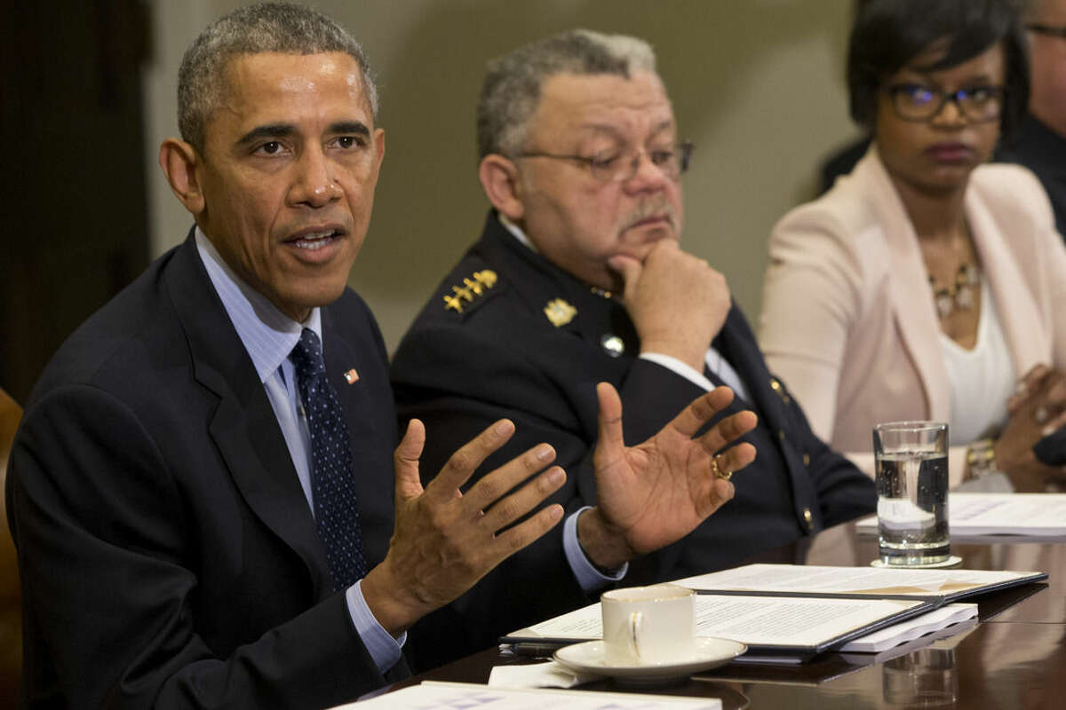 President Barack Obama speaks during a meeting with members of the Task Force on 21st Century Policing, Monday, March 2, 2015, in the Roosevelt Room of the White House in Washington. From left are, the president, Philadelphia Police Commissioner Charles Ramsey, and Brittany Packnett, executive director of Teach For America in St. Louis, Missouri. (AP Photo/Jacquelyn Martin)