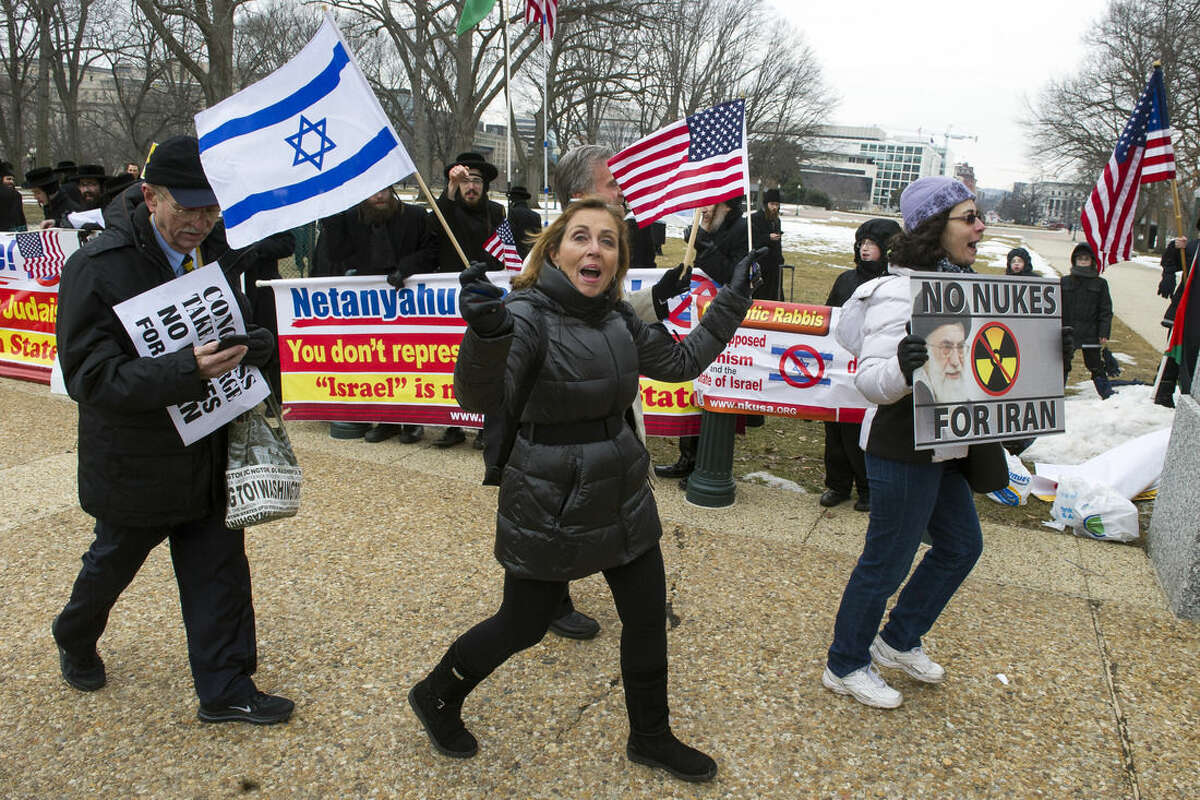 Pro Israel demonstrators walks past anti-Israel demonstrators on Capitol Hill in Washington, Tuesday, March 3,2015, while Israeli Prime Minister Benjamin Netanyahu addressed a Joint Session of Congress. (AP Photo/Cliff Owen)