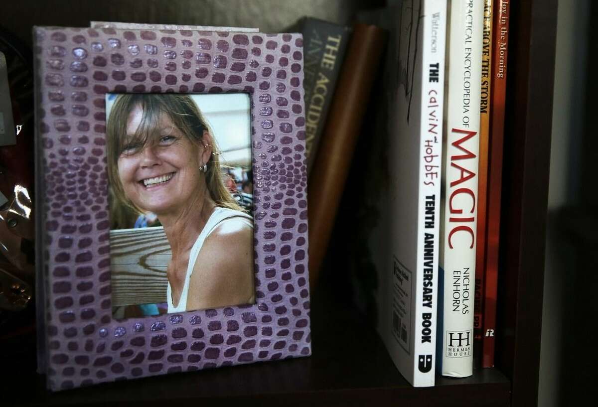 In this Friday, Feb. 20, 2015 photograph, a framed photograph of Charla Nash, taken before she was attacked by a chimpanzee, sits on a bookshelf at her second-story apartment in Boston. The Department of Defense is following Nash's progress, after funding her full-face transplant surgery in 2011. Nash lost her face, eyes and hands after being mauled by her boss's pet in 2009. The military is hoping the information they learn from Nash's rehabilitation can help young, seriously disfigured soldiers returning from war. (AP Photo/Charles Krupa)