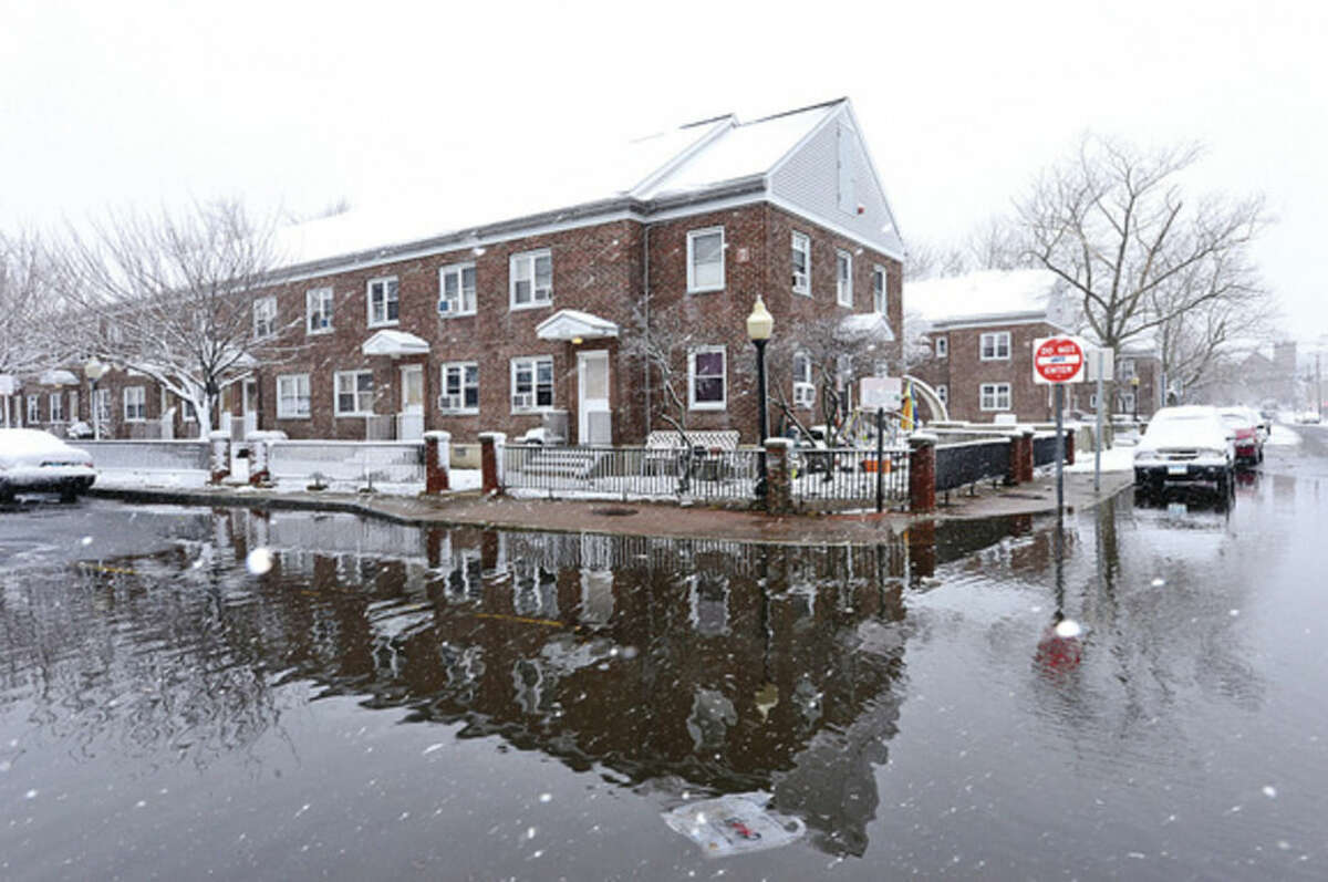 Snowstorm Saturn which blew back over Norwalk after going out into the Atlantic left 3 inhces of snow on the ground and flooding on water St near Washington Village. Hour photo / Erik Trautmann